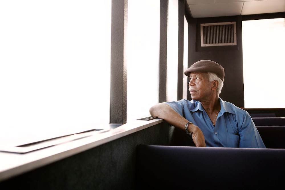 Senior man looking through window