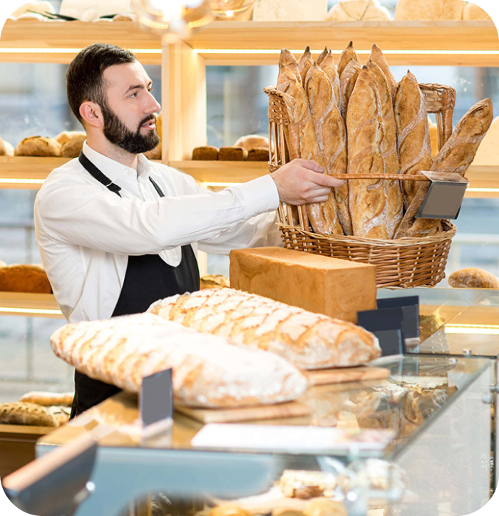 business owner holding a basket of bread