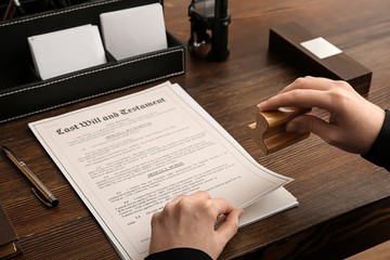 person stamping last will and testament