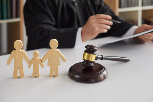 judge and wooden figurines of family law